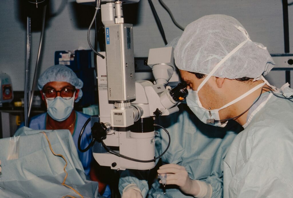 Surgeons performing cataract surgery using an operating microscope in a clinical operating room