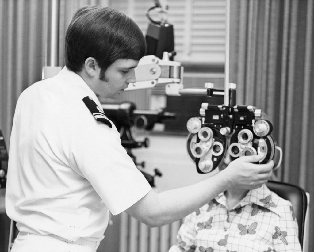 Optometrist examining a patient's eyes, part of a comprehensive exam that supports glaucoma awareness and early screening