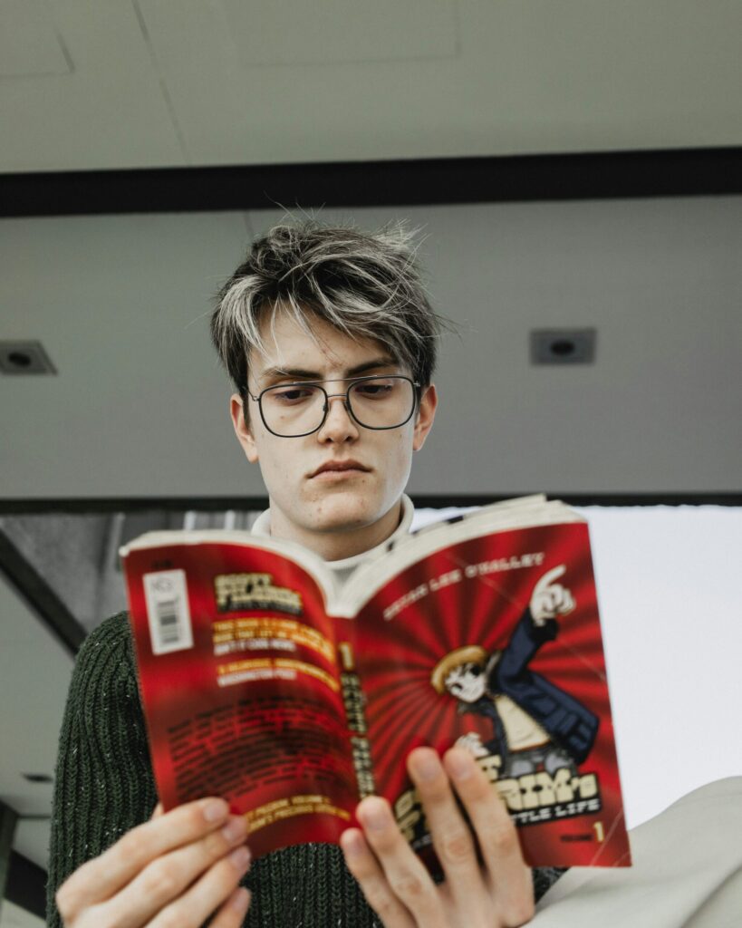 Man reading a book while wearing glasses, illustrating common eye myths about reading and eyewear