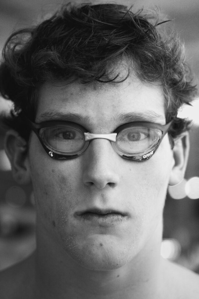 Young athlete wearing protective sports eye protection goggles during swim practice